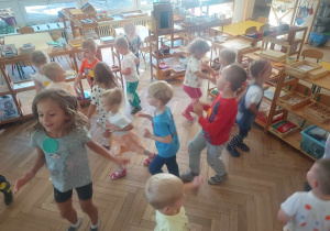 Na zdjęciu widać dzieci podczas zabawy muzyczno - ruchowej " Kropka do kropki"