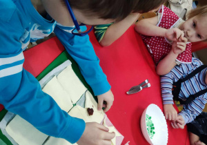 Dziecko zawija ciasto formując wiatraczek