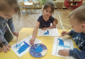 Dzieci malują motyle.