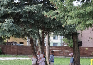 dzieci przytulają się do drzew