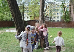 dzieci przytulają się do drzew