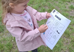 dziewczynka pokazuje obrazek na kartce