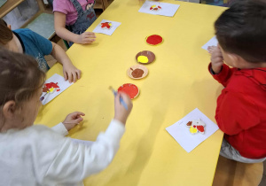 dzieci malują farbali liście z masy solnej