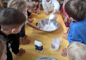 dziewczynka wsypuje sól do miski