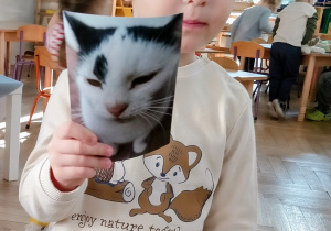 Chłopiec pokazuje zdjęcie swojego kotka.