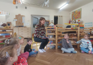 Na zdjęciu widać mamę Tosi, która wita się z dziećmi i będzie czytała bajkę o Czerwonym Kapturku