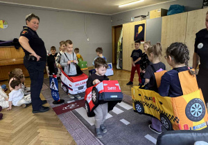 Zdjęcie przedstawia dzieci poruszające się po drodze autkami z gąbki.