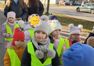 Dzieci rozdają ulotki dwóm paniom.