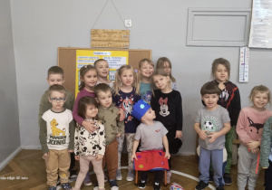 Dzieci stoją wokół jubilata.