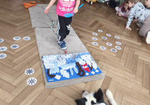 Dzieci chowają smaczki w macie węchowej a pies czeka