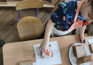 Na zdjęciu widzimy dzieci, które tworzą zdrowe tosty.