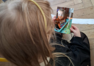 dziecwzynka patrzy na fotografię