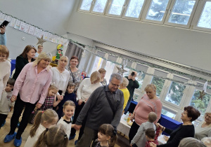 Na zdjęciu widzimy dziadków bawiących się ze swoimi wnukami w zabawy ruchowe.