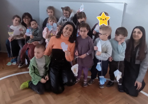 Dzieci stoją z panią i prezentują swoje prace.