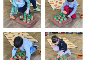 Na zdjęciu widzimy dzieci, które chowają pod materiałowymi marchewkami smakołyki dla piesków.