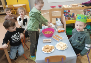 Dzieci częstują się słodyczami.