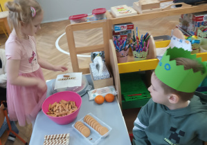 Dzieci częstują się słodyczami.