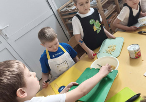 Dzieci wrzucają pokrojone produkty do miski