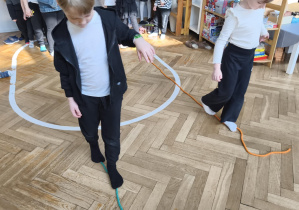 Na zdjęciu widzimy dzieci, które wykonują ćwiczenia sprawnościowe.