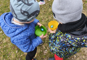 Na zdjęciu widzimy dzieci, które patrzą na odnalezione jajeczka.