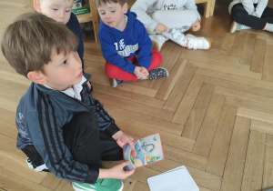 chłopiec opowiada co ma na obrazku