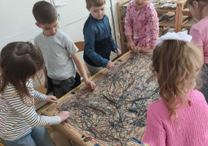 Dzieci uczestniczą w zabawie Edukacji przez ruch - malując spirale i owale