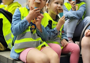 Na zdjęciu dziewczynka je loda.